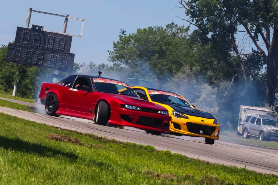 A yellow and red car drifting in tandem